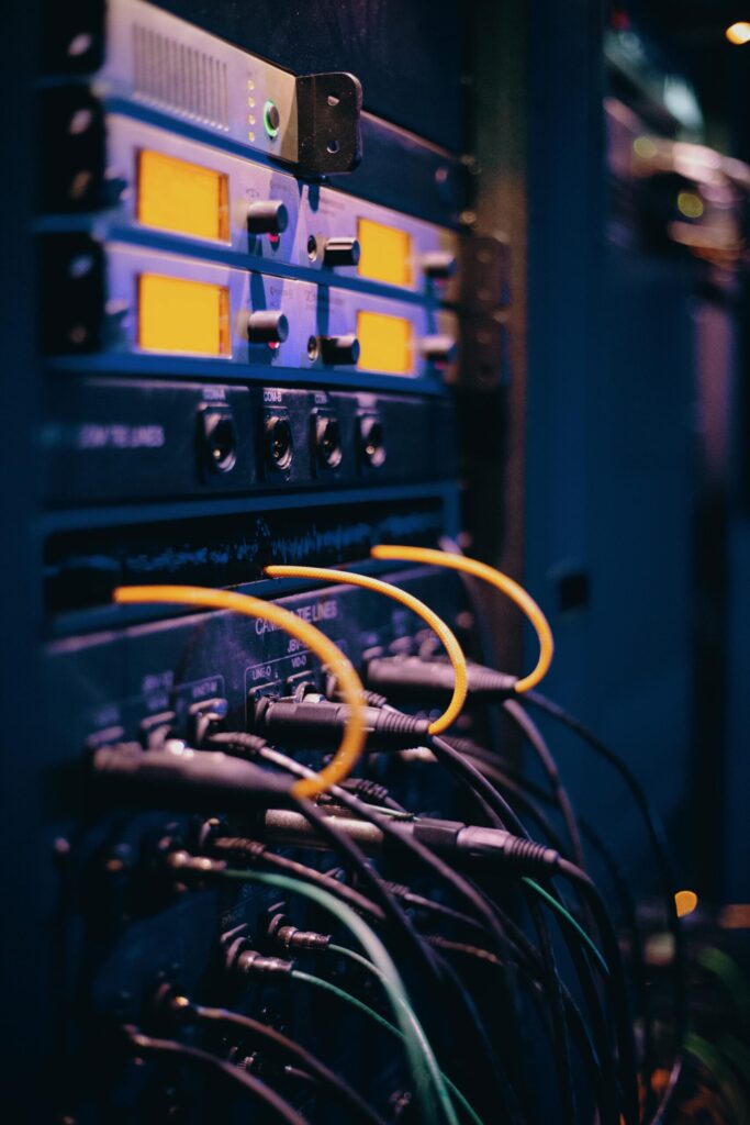 Close-up of network cables and ports in a server rack, showcasing connectivity and representing the CIA Triad principle of Availibility